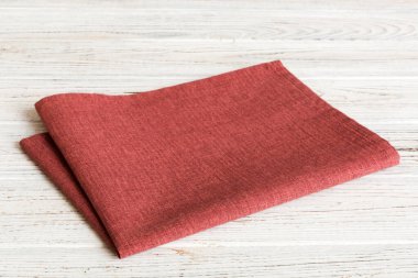 top view with red empty kitchen napkin isolated on table background. Folded cloth for mockup with copy space, Flat lay. Minimal style.