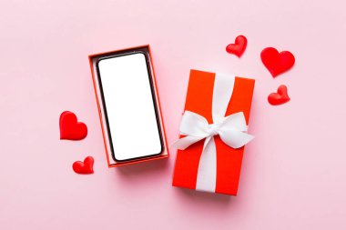 Opened gift box with ribbon and phone on color background, top view. Blank open box packaging mockup , Template for your design - branding mockup.