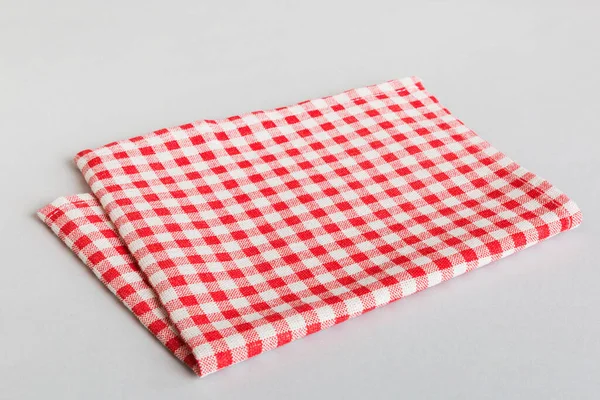 top view with red empty kitchen napkin isolated on table background. Folded cloth for mockup with copy space, Flat lay. Minimal style.