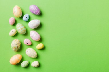 Happy Easter concept. Preparation for holiday. Easter eggs on colored background. flat lay top view copy space banner.