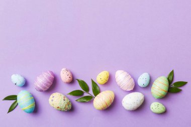 Happy Easter concept. Preparation for holiday. Easter eggs on colored background. flat lay top view copy space banner.