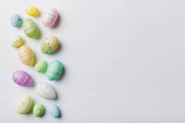 Happy Easter concept. Preparation for holiday. Easter eggs on colored background. flat lay top view copy space banner.