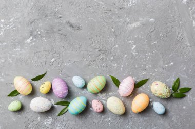 Happy Easter concept. Preparation for holiday. Easter eggs on colored background. flat lay top view copy space banner.
