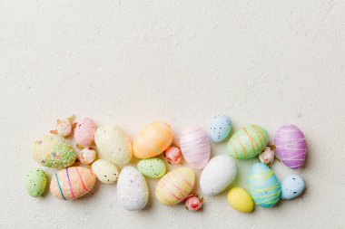 Happy Easter concept. Preparation for holiday. Easter eggs on colored background. flat lay top view copy space banner.