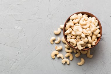 cashew nuts in wooden bowl on table background. top view. Space for text. Healthy food