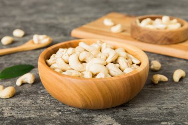 cashew nuts in wooden bowl on table background. top view. Space for text. Healthy food