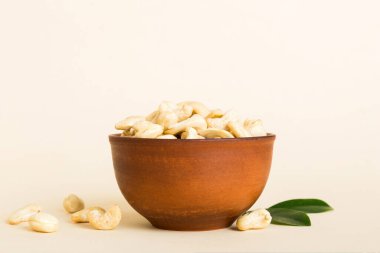 cashew nuts in wooden bowl on table background. top view. Space for text. Healthy food