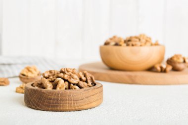 Fresh healthy walnuts in bowl on colored table background. Top view Healthy eating bertholletia concept. Super foods.