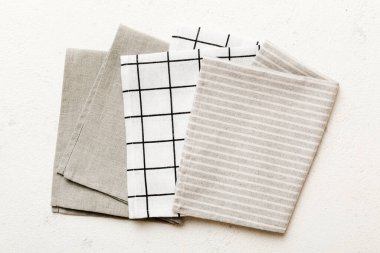 top view with gray kitchen napkin isolated on table background. Folded cloth for mockup with copy space, Flat lay. Minimal style.
