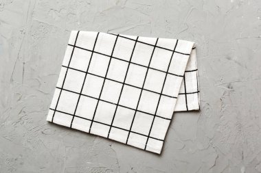 top view with white empty kitchen napkin isolated on table background. Folded cloth for mockup with copy space, Flat lay. Minimal style.