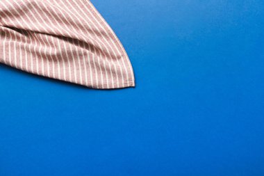 top view with red empty kitchen napkin isolated on table background. Folded cloth for mockup with copy space, Flat lay. Minimal style.