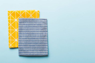 top view with blue kitchen napkin isolated on table background. Folded cloth for mockup with copy space, Flat lay. Minimal style.