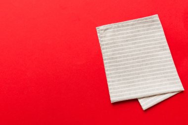 top view with gray kitchen napkin isolated on table background. Folded cloth for mockup with copy space, Flat lay. Minimal style.