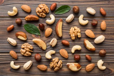 Composition of nuts , flat lay - mix hazelnuts, cashews, almonds on table background. healthy eating concepts and food background.