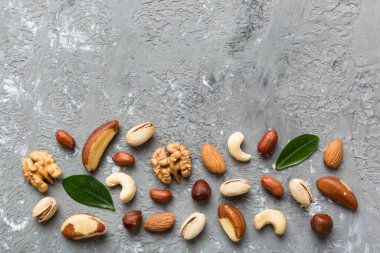 Composition of nuts , flat lay - mix hazelnuts, cashews, almonds on table background. healthy eating concepts and food background.