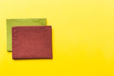 top view with red empty kitchen napkin isolated on table background. Folded cloth for mockup with copy space, Flat lay. Minimal style.