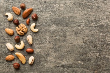 Composition of nuts , flat lay - mix hazelnuts, cashews, almonds on table background. healthy eating concepts and food background.