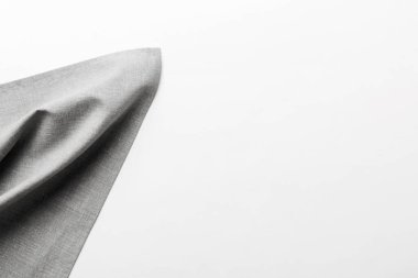 top view with gray kitchen napkin isolated on table background. Folded cloth for mockup with copy space, Flat lay. Minimal style.