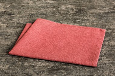 top view with red empty kitchen napkin isolated on table background. Folded cloth for mockup with copy space, Flat lay. Minimal style.
