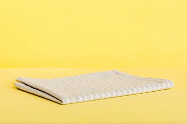 top view with gray kitchen napkin isolated on table background. Folded cloth for mockup with copy space, Flat lay. Minimal style.