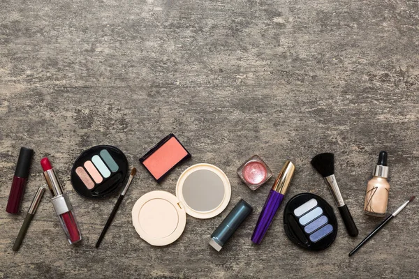 Professional makeup tools. Top view. Flat lay. Beauty, decorative cosmetics. Makeup brushes set and color eyeshadow palette on table background. Minimalistic style.