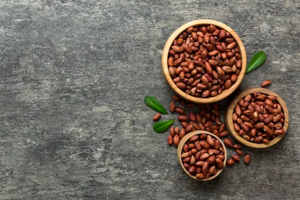 stock image Fresh healthy peanuts in bowl on colored table background. Top view Healthy eating bertholletia concept. Super foods.