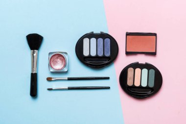 Professional makeup tools. Top view. Flat lay. Beauty, decorative cosmetics. Makeup brushes set and color eyeshadow palette on table background. Minimalistic style.