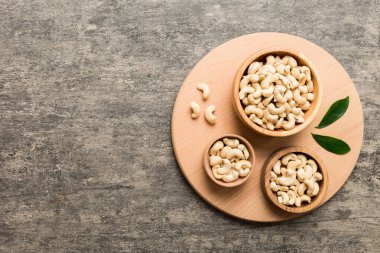 cashew nuts in wooden bowl on table background. top view. Space for text. Healthy food