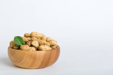 Fresh healthy peanuts in bowl on colored table background. Top view Healthy eating bertholletia concept. Super foods.