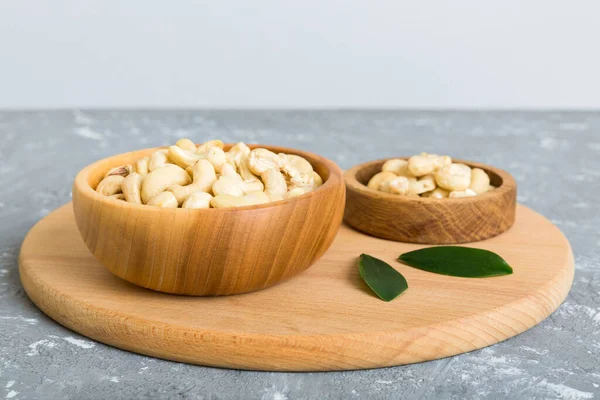 stock image cashew nuts in wooden bowl on table background. top view. Space for text. Healthy food