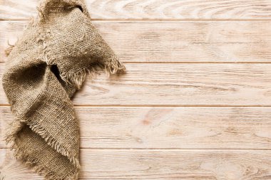 Old burlap fabric napkin, sackcloth on table background. top view with copy space.