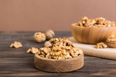 Fresh healthy walnuts in bowl on colored table background. Top view Healthy eating bertholletia concept. Super foods.