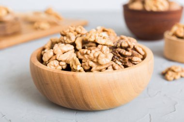 Fresh healthy walnuts in bowl on colored table background. Top view Healthy eating bertholletia concept. Super foods.