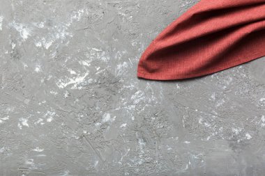 top view with red empty kitchen napkin isolated on table background. Folded cloth for mockup with copy space, Flat lay. Minimal style.