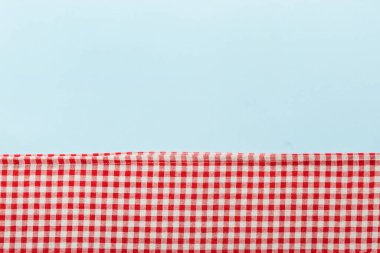 top view with red empty kitchen napkin isolated on table background. Folded cloth for mockup with copy space, Flat lay. Minimal style.