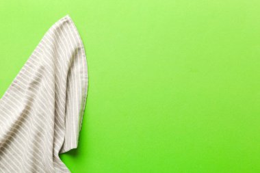 top view with gray kitchen napkin isolated on table background. Folded cloth for mockup with copy space, Flat lay. Minimal style.