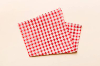 top view with red empty kitchen napkin isolated on table background. Folded cloth for mockup with copy space, Flat lay. Minimal style.