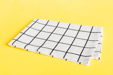 top view with white empty kitchen napkin isolated on table background. Folded cloth for mockup with copy space, Flat lay. Minimal style.