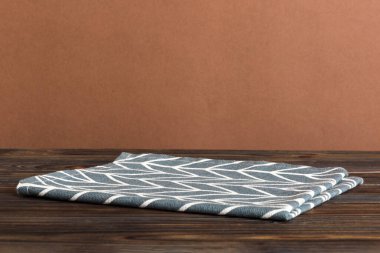 top view with blue kitchen napkin isolated on table background. Folded cloth for mockup with copy space, Flat lay. Minimal style.