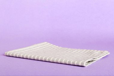 top view with gray kitchen napkin isolated on table background. Folded cloth for mockup with copy space, Flat lay. Minimal style.