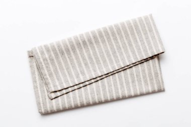 top view with gray kitchen napkin isolated on table background. Folded cloth for mockup with copy space, Flat lay. Minimal style.