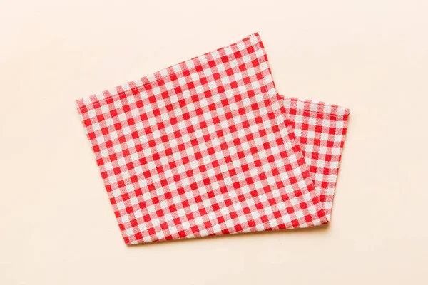 stock image top view with red empty kitchen napkin isolated on table background. Folded cloth for mockup with copy space, Flat lay. Minimal style.