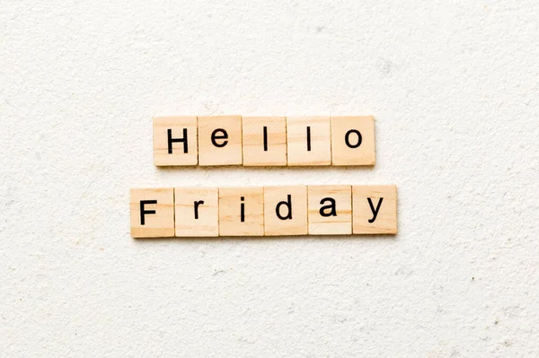 hello friday word written on wood block. hello friday text on cement table for your desing, concept.