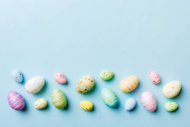 Happy Easter concept. Preparation for holiday. Easter eggs on colored background. flat lay top view copy space banner.