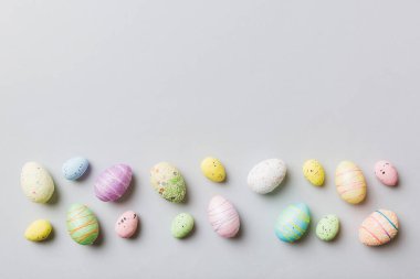 Happy Easter concept. Preparation for holiday. Easter eggs on colored background. flat lay top view copy space banner.