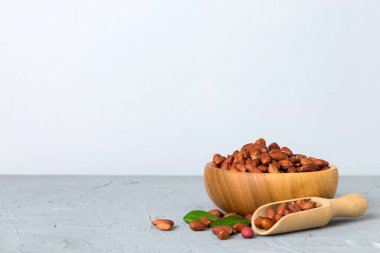 Fresh healthy peanuts in bowl on colored table background. Top view Healthy eating bertholletia concept. Super foods.