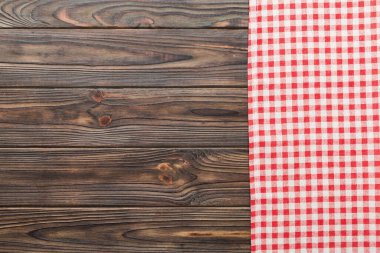 top view with red empty kitchen napkin isolated on table background. Folded cloth for mockup with copy space, Flat lay. Minimal style.