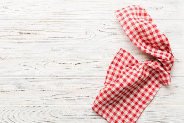 top view with red empty kitchen napkin isolated on table background. Folded cloth for mockup with copy space, Flat lay. Minimal style.