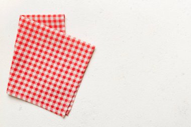 top view with red empty kitchen napkin isolated on table background. Folded cloth for mockup with copy space, Flat lay. Minimal style.