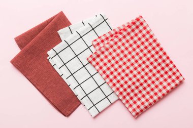 top view with red empty kitchen napkin isolated on table background. Folded cloth for mockup with copy space, Flat lay. Minimal style.
